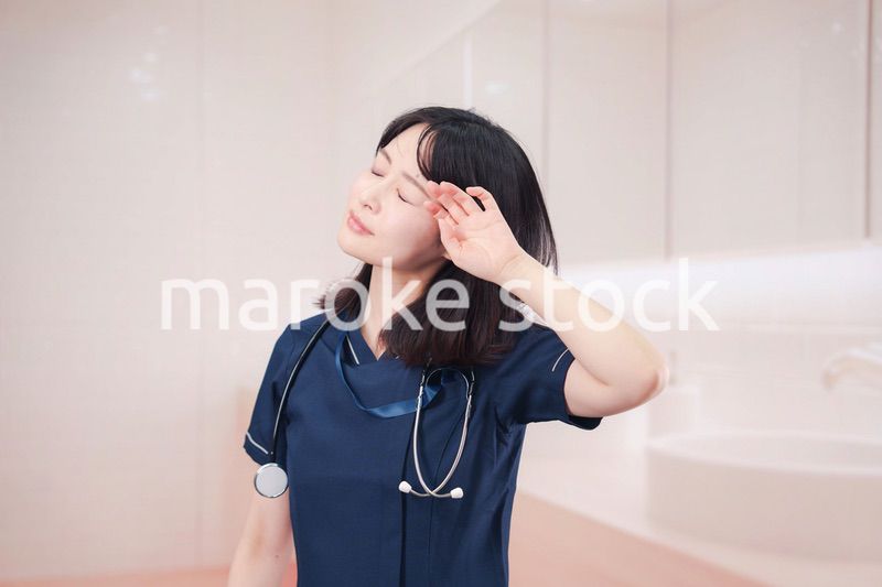 化粧室で身だしなみを整える医療従事者の女性