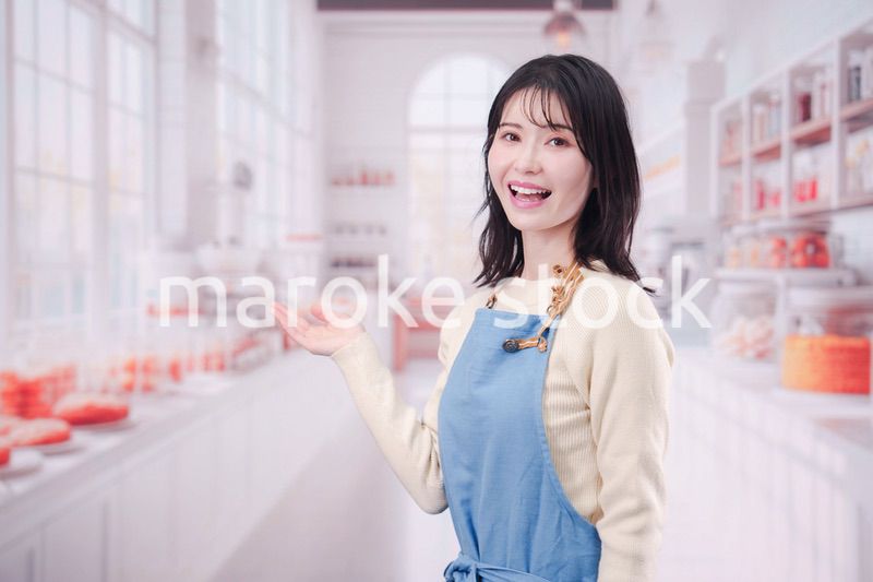 笑顔でお菓子作りをするパティシエの若い女性