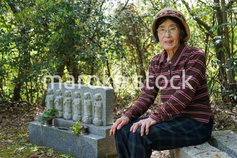 お墓参りをする高齢者