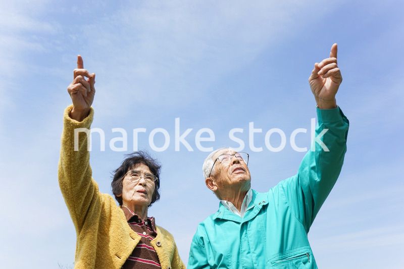 空を指差す高齢夫婦