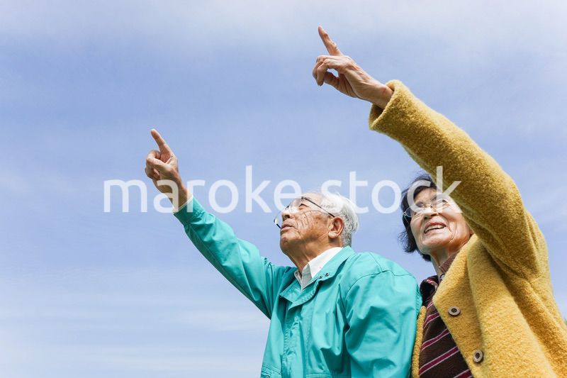 空を指差す高齢夫婦