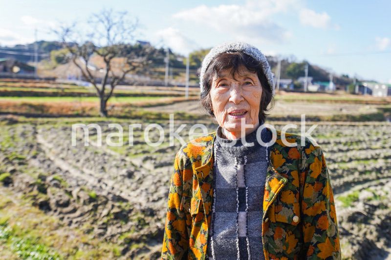 田舎でほほえむ高齢の女性