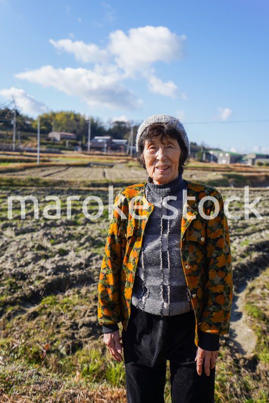 田舎でほほえむ高齢の女性