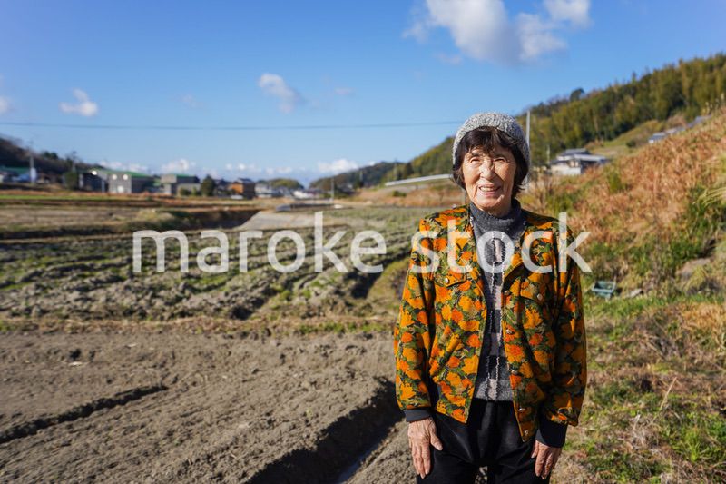 田舎でほほえむ高齢の女性