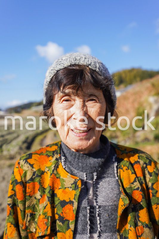 田舎でほほえむ高齢の女性