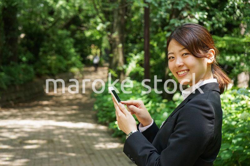 スマホでメッセージを打つビジネスウーマン