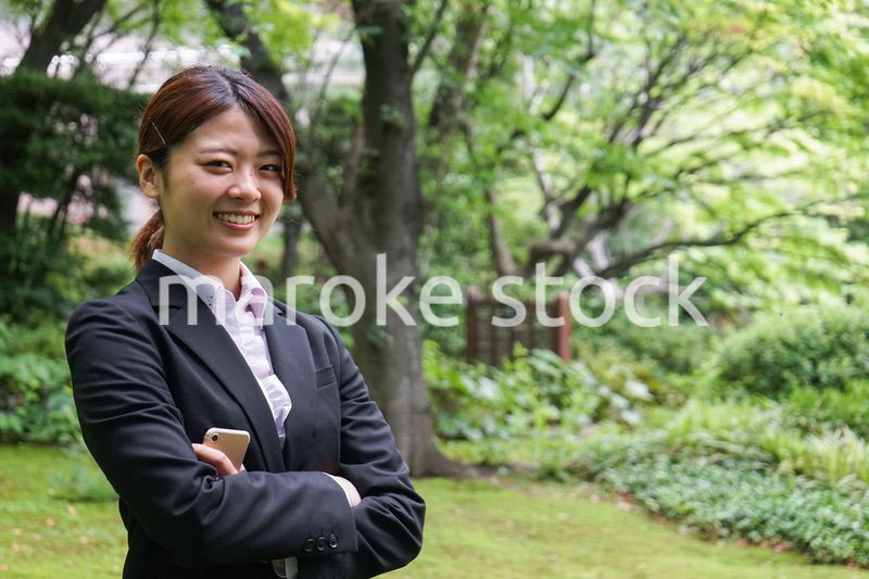 笑顔で外を歩くビジネスウーマン