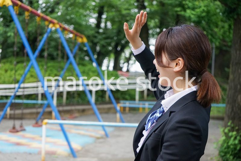 笑顔で手を振る制服姿の学生