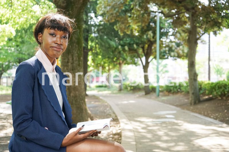 公園で読書をする黒人女性