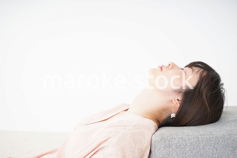 体調不良で横たわる若い女性