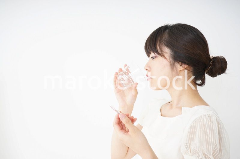 内服薬を服用する若い女性