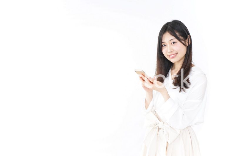 笑顔でスマホを使う若い女性