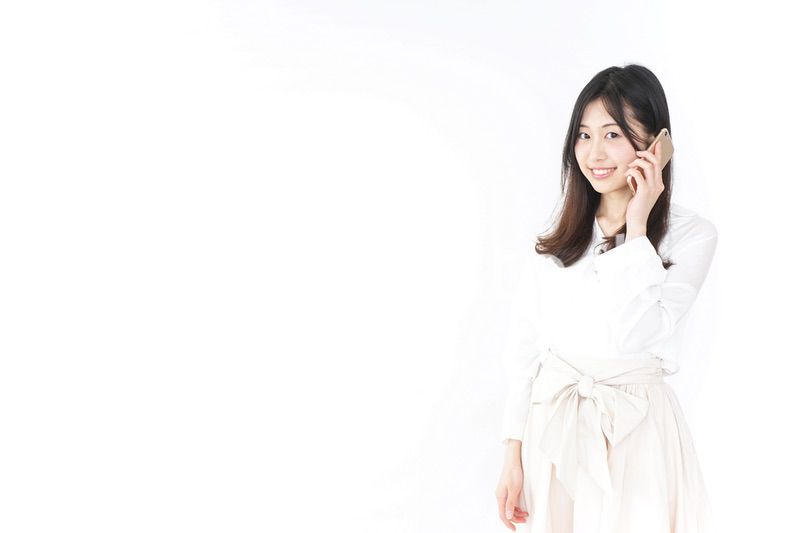 笑顔でスマホを使う若い女性