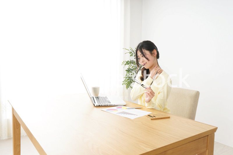 オフィスワークで疲れた若い女性