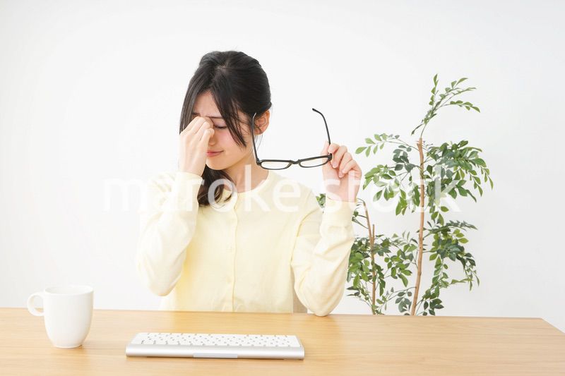 オフィスワークで疲れた若い女性