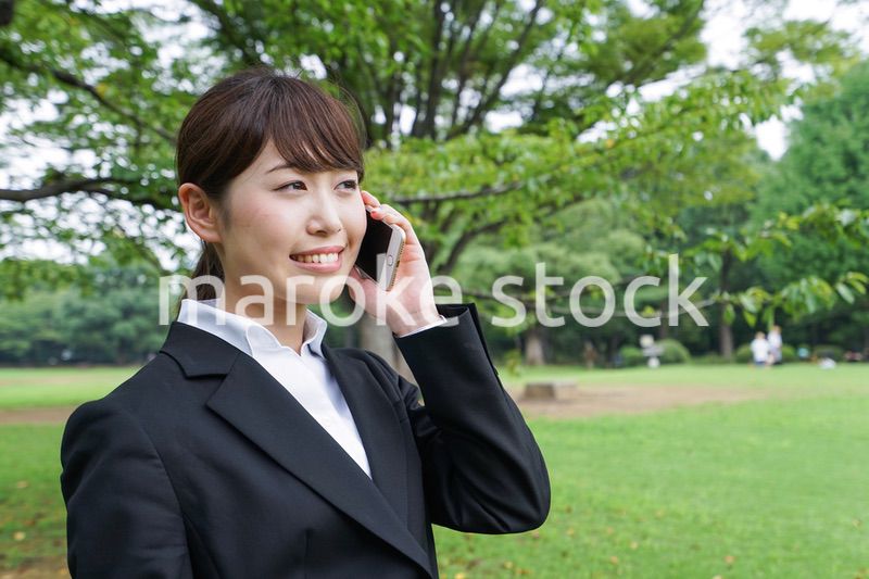電話をするスーツ姿の若い女性