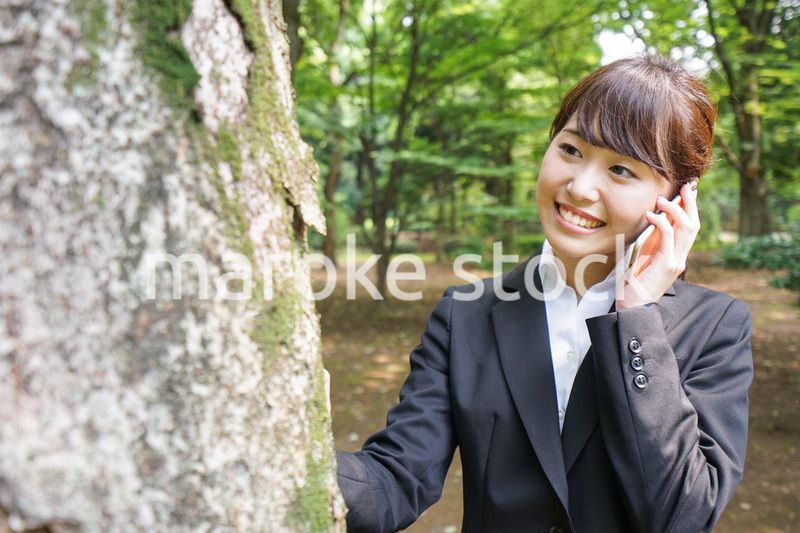 電話をするスーツ姿の若い女性
