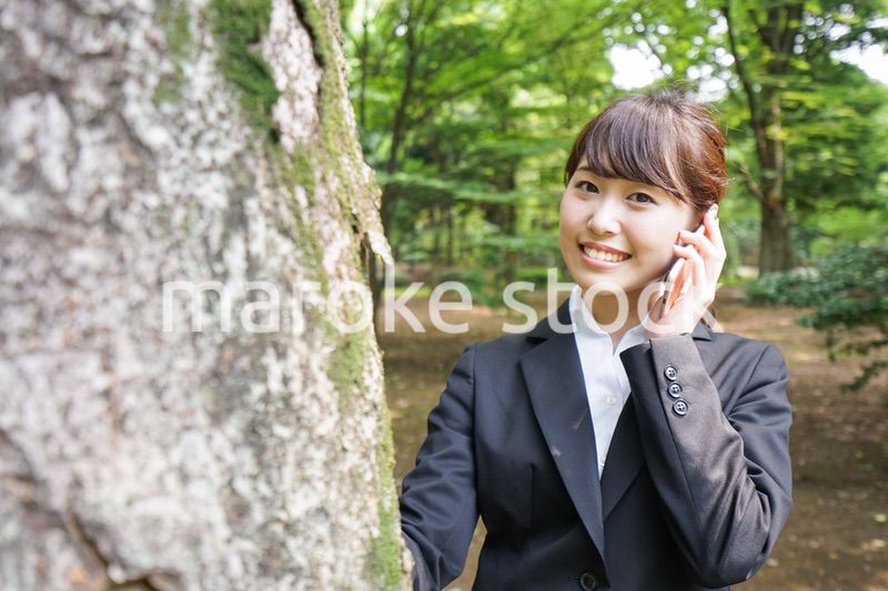 電話をするスーツ姿の若い女性