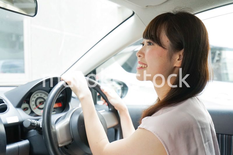 車を運転する若い日本人女性