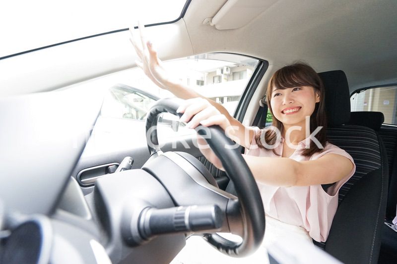 手を振る女性ドライバー