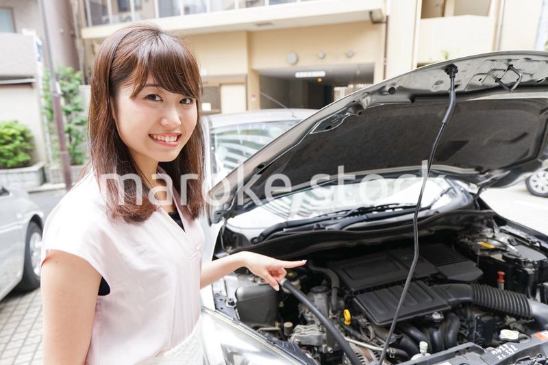 車のメンテナンスをする女性