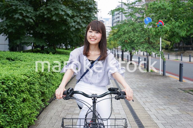 電動自転車で子供を送るお母さん