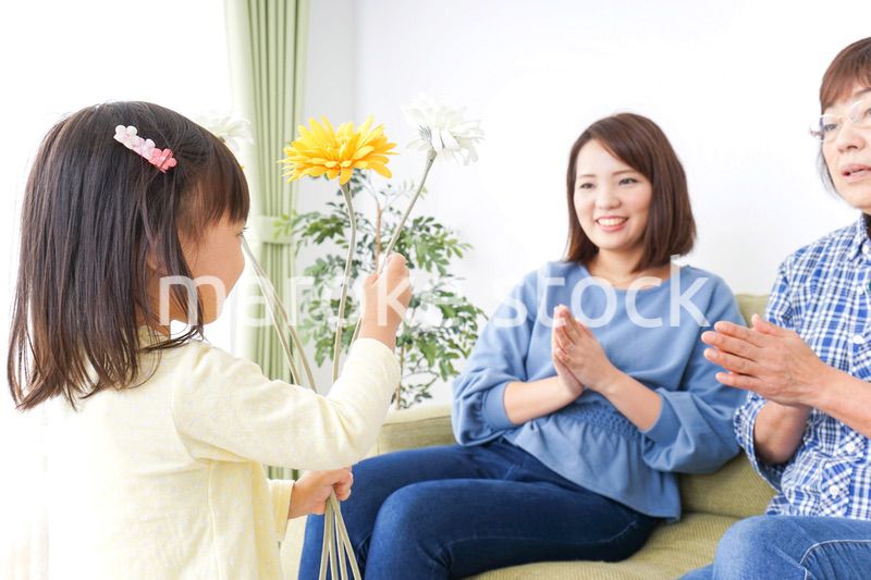 おばあちゃんにお花を渡す子供