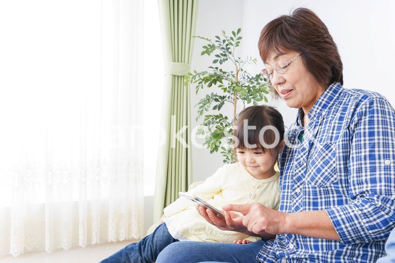 おばあちゃんとスマホを使う子供
