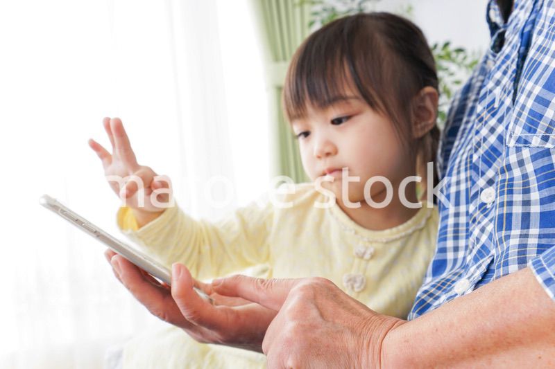おばあちゃんとスマホを使う子供