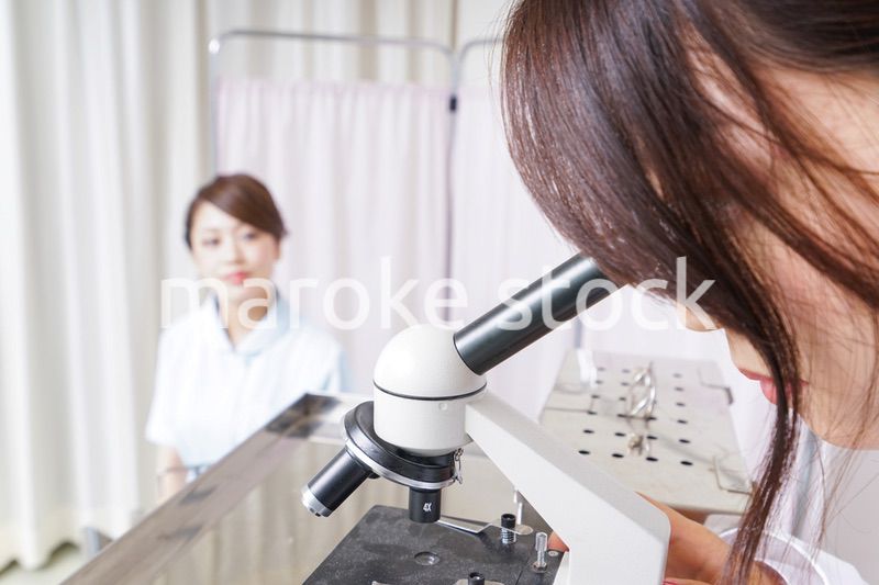 顕微鏡を見る医師と看護師