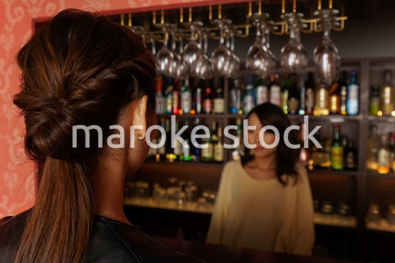 バーカウンターに座る女性