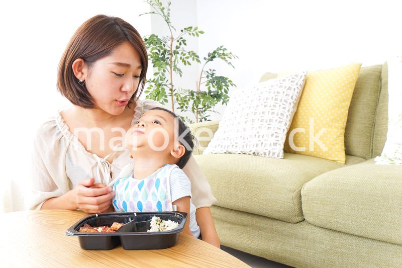 子どもにごはんを食べさせる母親