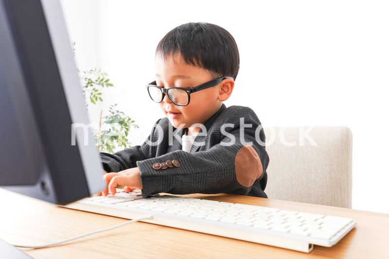 スーツを着て仕事をする子供ビジネスマン