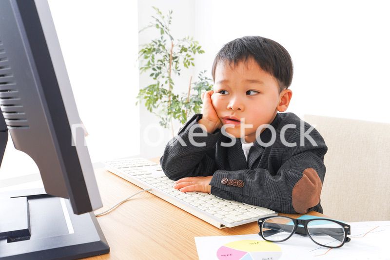 スーツを着て仕事をする子供ビジネスマン