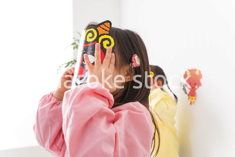 節分のお面をかぶる子どもたち