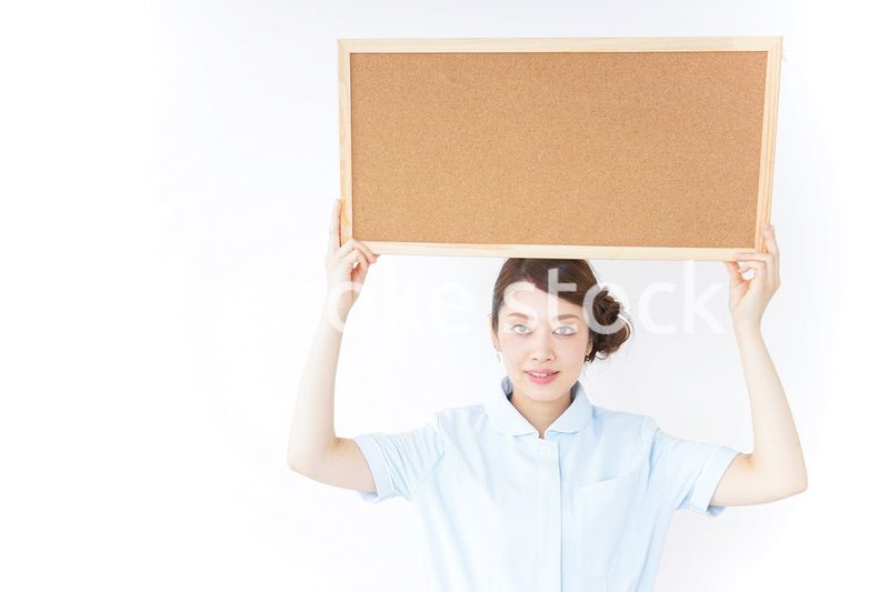 コルクボードを持つ看護師