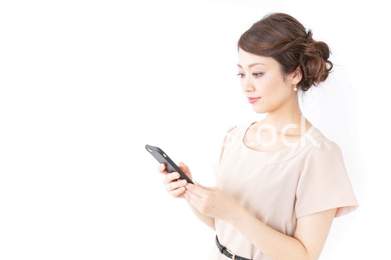 スマホを使うおしゃれ着の女性