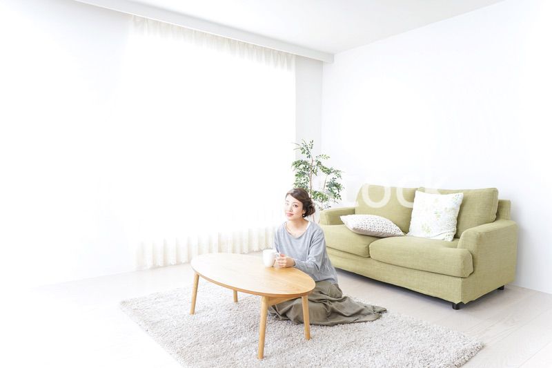家でコーヒーを飲みくつろぐ女性