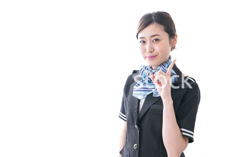 指をさすキャビンアテンダント