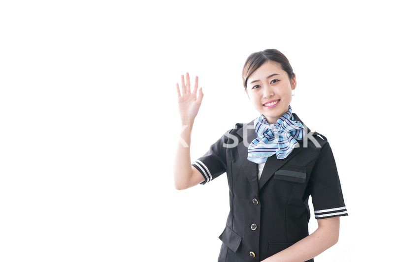 手を振るキャビンアテンダント