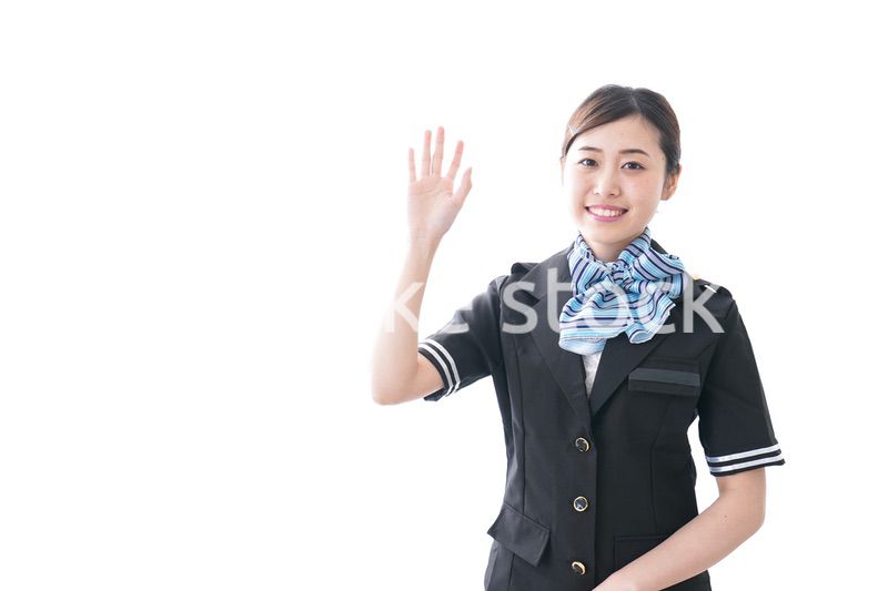 手を振るキャビンアテンダント