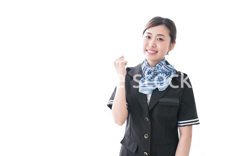 ガッツポーズをするキャビンアテンダント