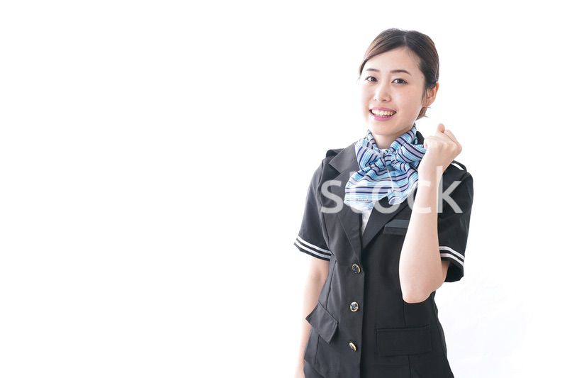 ガッツポーズをするキャビンアテンダント