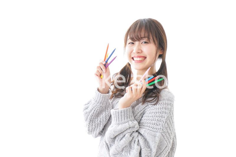 カラフルな色鉛筆を持つ女性