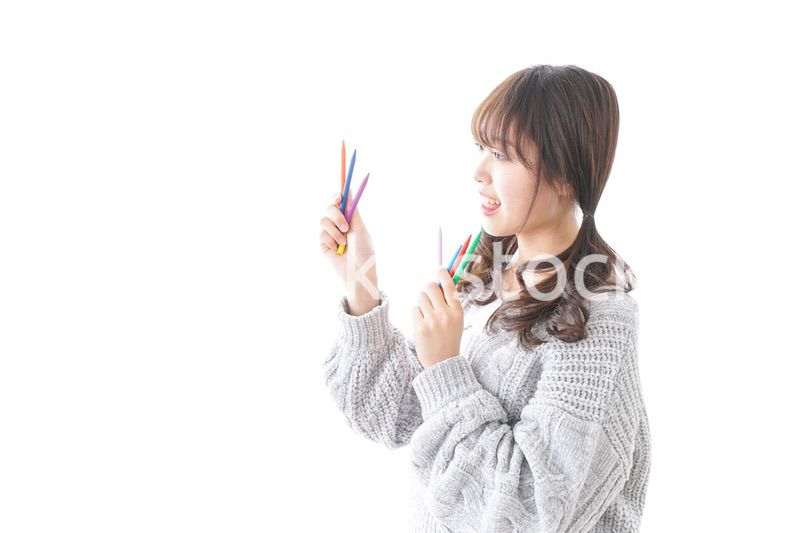カラフルな色鉛筆を持つ女性