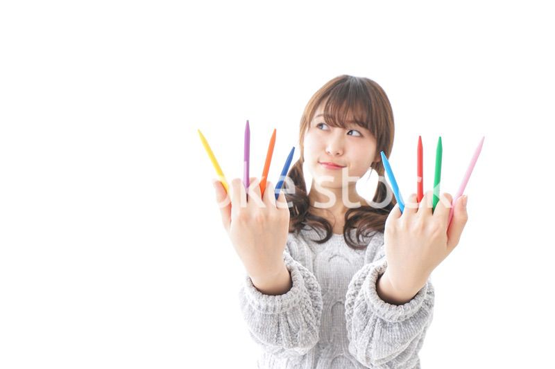 カラフルな色鉛筆を持つ女性