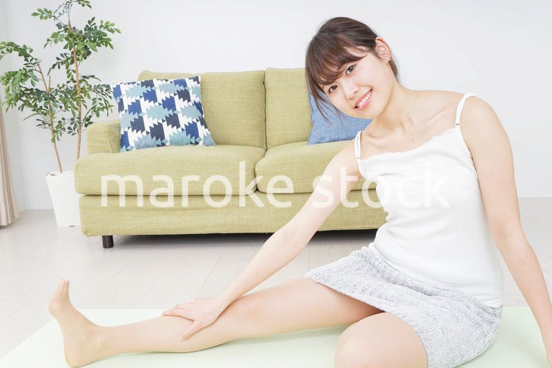 部屋でストレッチをする女性