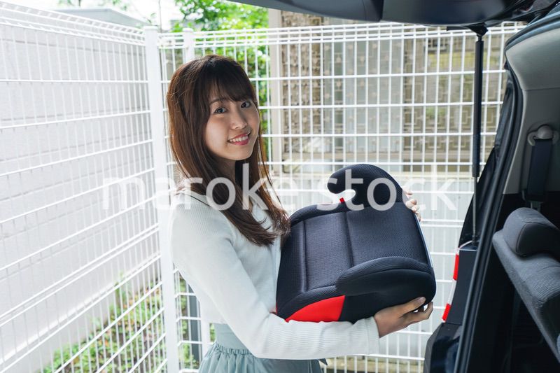 チャイルドシートを持つ女性