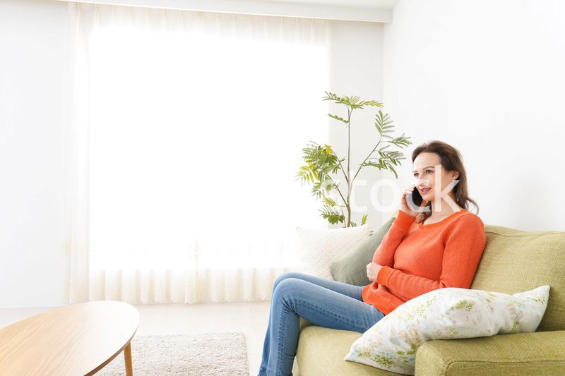 家で通話をする若い女性