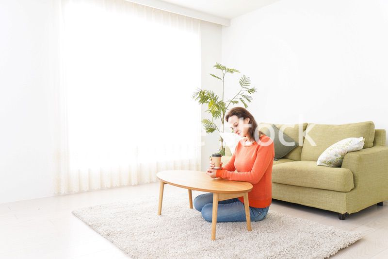 家でコーヒーを飲む若い女性